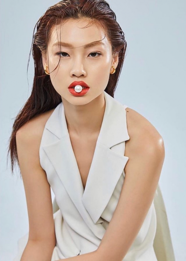 HoYeon Jung from Squid Game poses for photos on her way to the